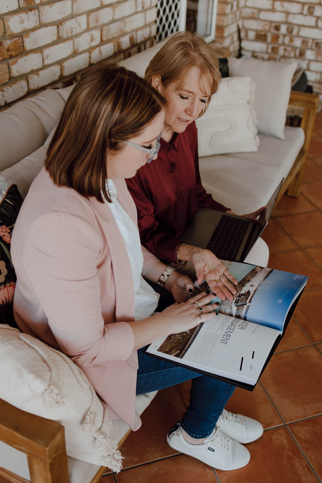 Deb and Sarah-Joy flipping through a magazine
